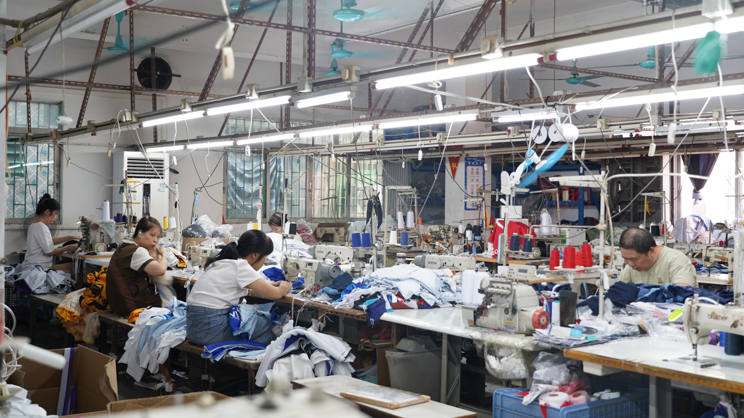 Dongguan sportswear factory production line with skilled workers sewing custom activewear garments