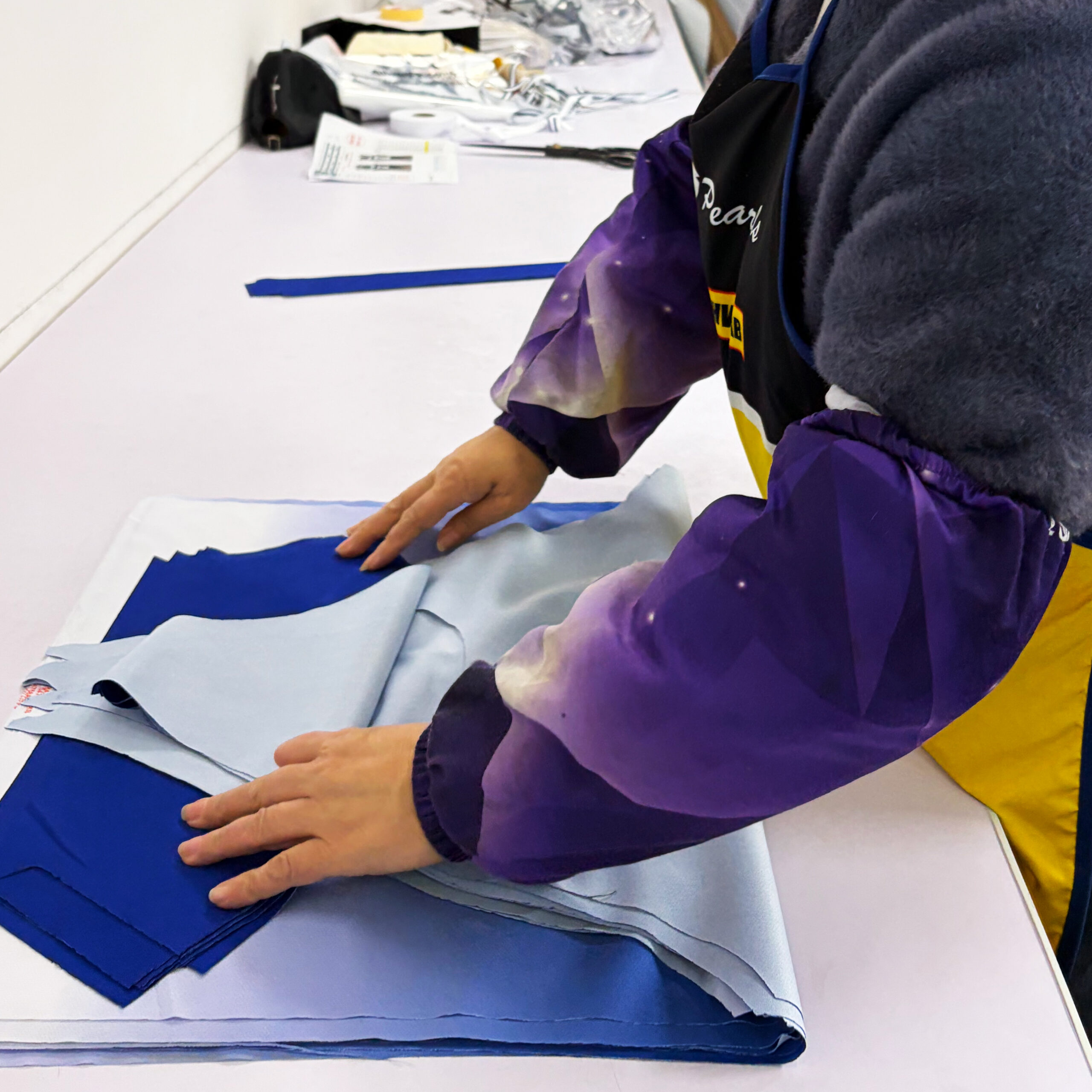 QC inspector checking dimensional accuracy of laser-cut fabric panels for quality control