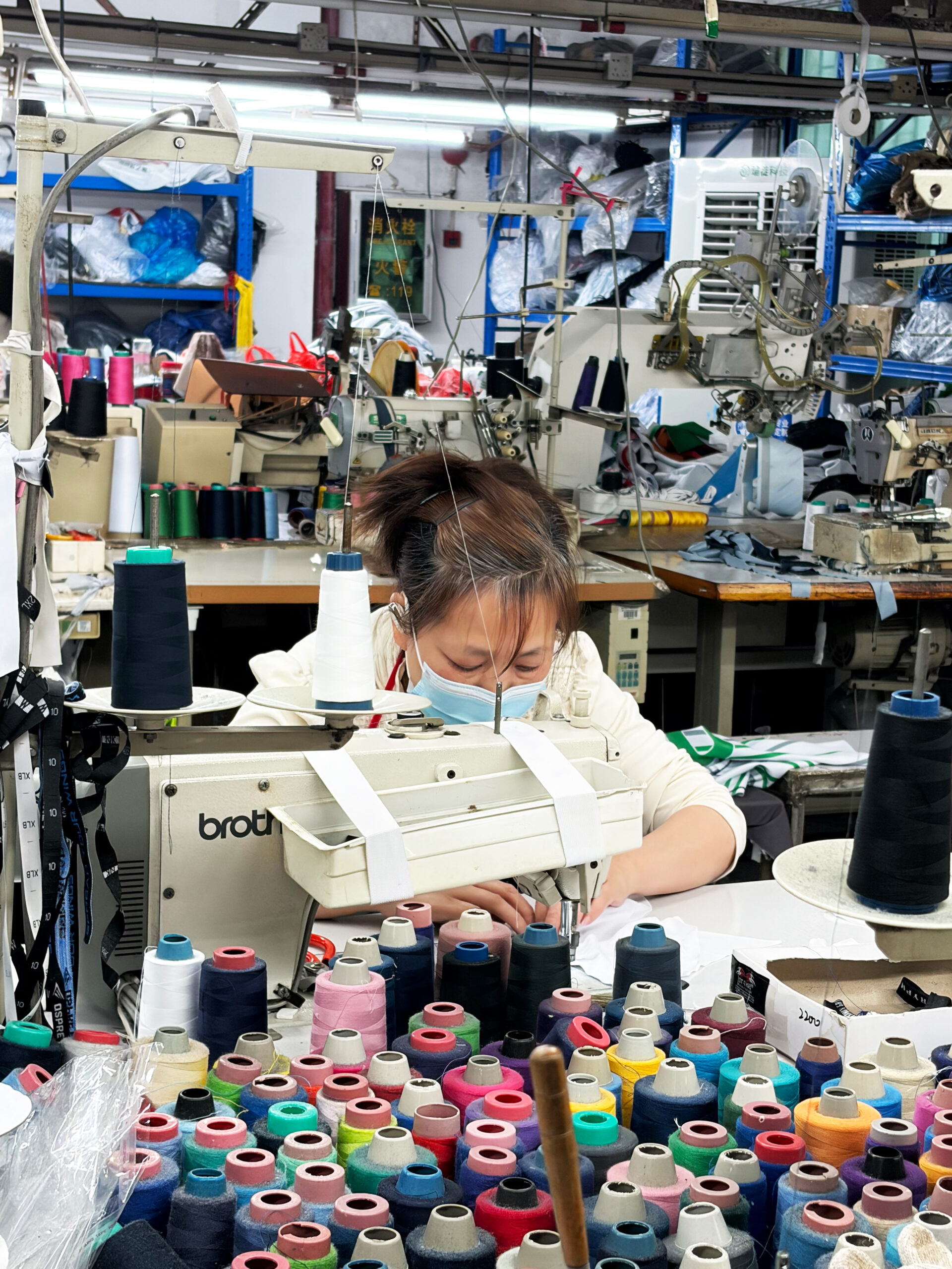 industrial sportswear factory utilizing 24-group 9-needle automated sewing lines for high-volume athletic apparel manufacturing